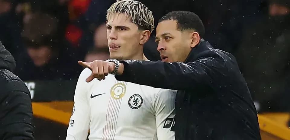 Player receiving instructions from coach on sideline