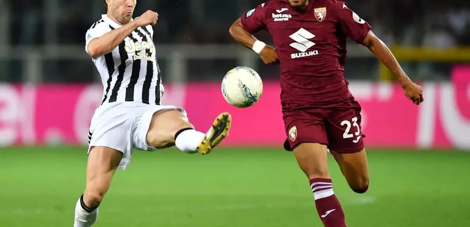 Player kicking the ball in Torino vs Juventus match