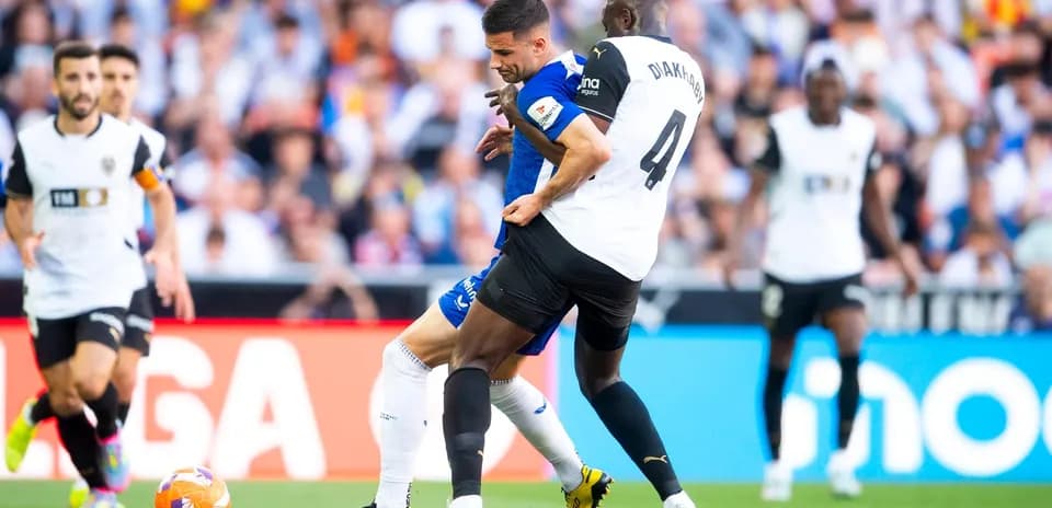 Players competing for the ball in La Liga match