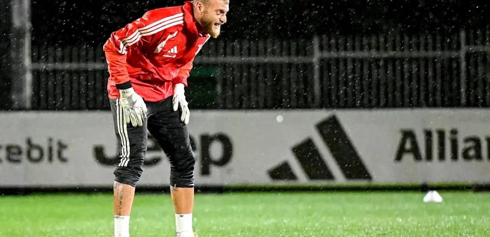 Goalkeeper training in rain on the pitch