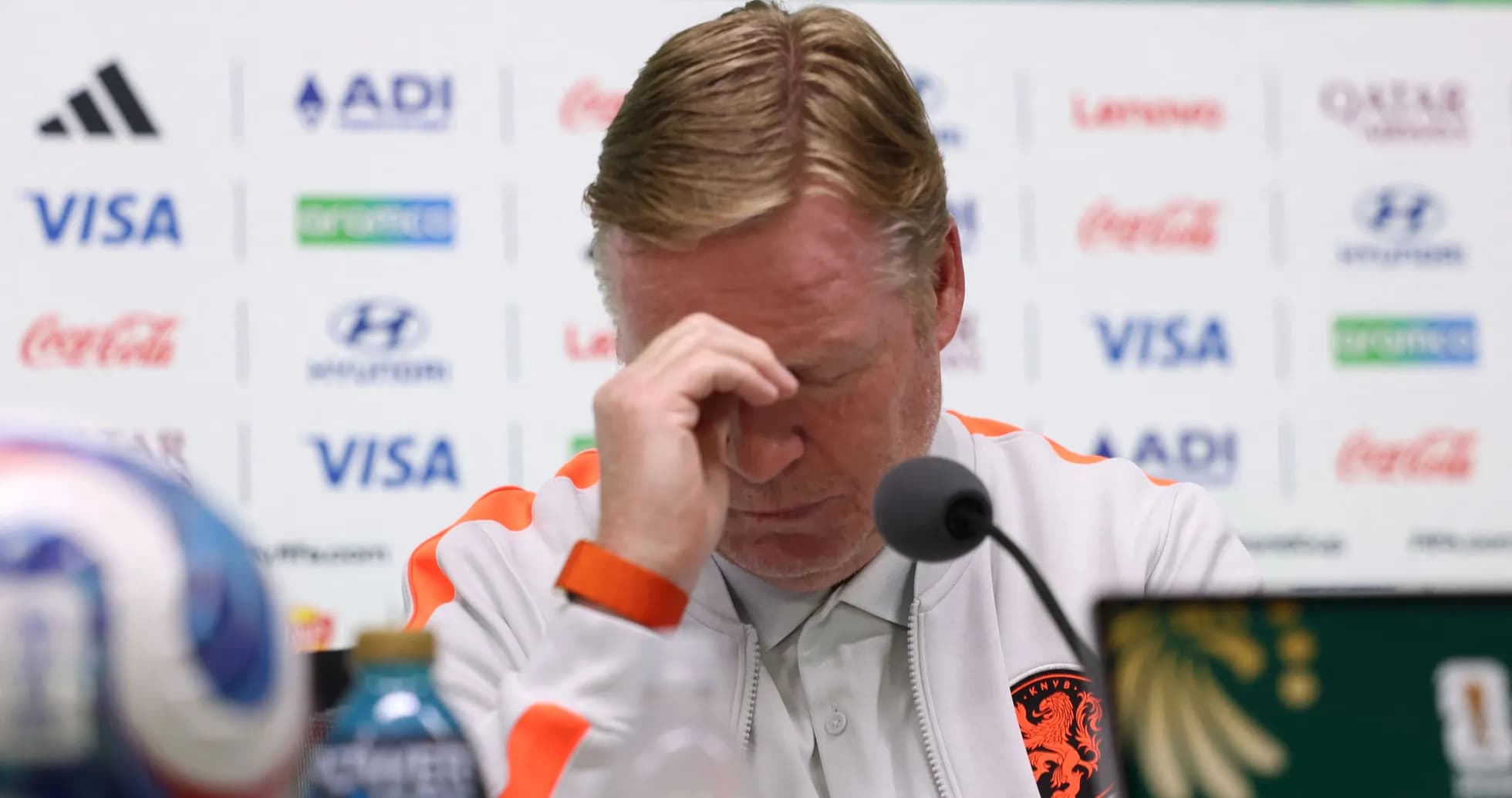 Manager at press conference with head bowed
