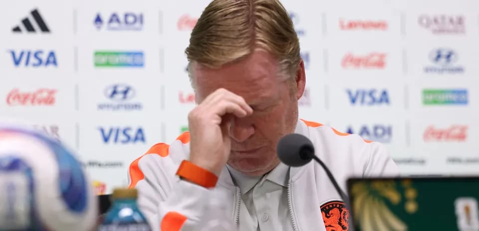 Manager at press conference with head bowed