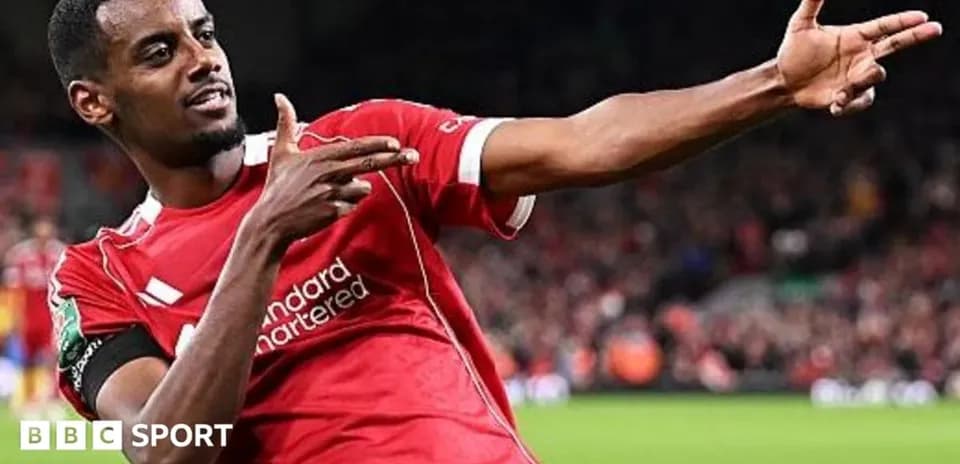 Player celebrating goal with hand gesture in stadium