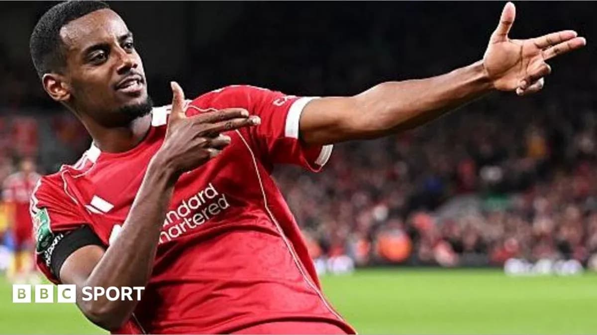 Player celebrating goal with hand gesture in stadium