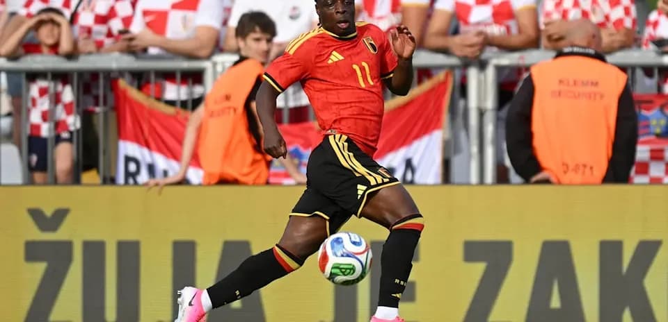 Belgium player running with ball during match