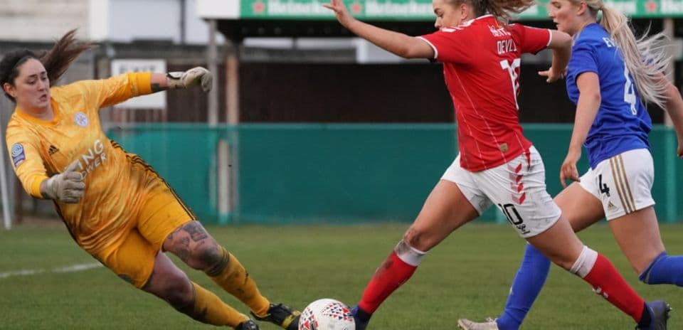 Goalkeeper attempting to save during women's football match