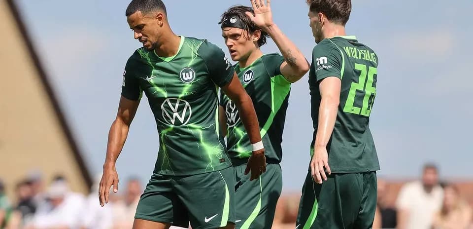 Wolfsburg players interacting on the field during match