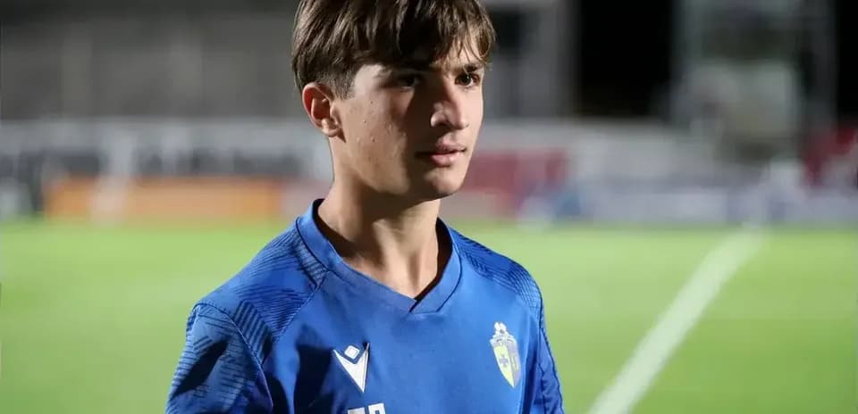 Young player wearing blue jersey on football field