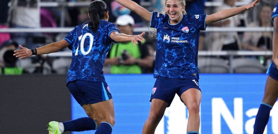 Players celebrating a goal during NWSL match