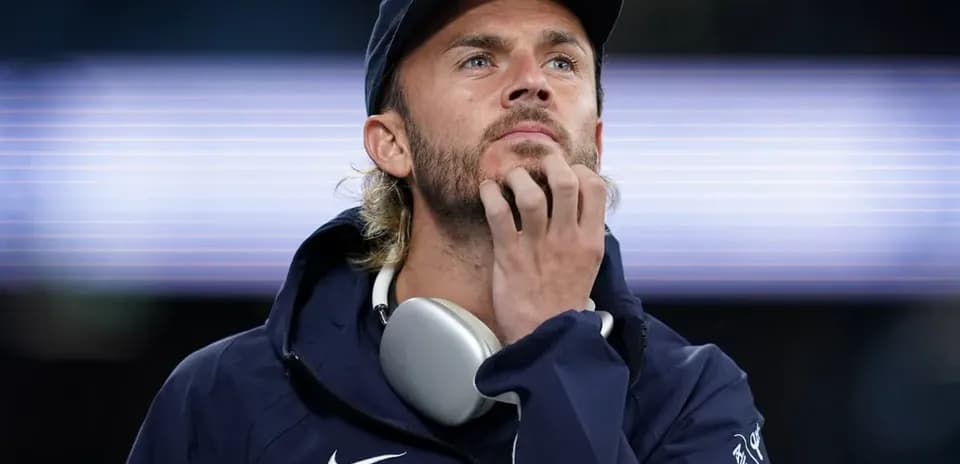 Man wearing headphones looking thoughtfully at distance