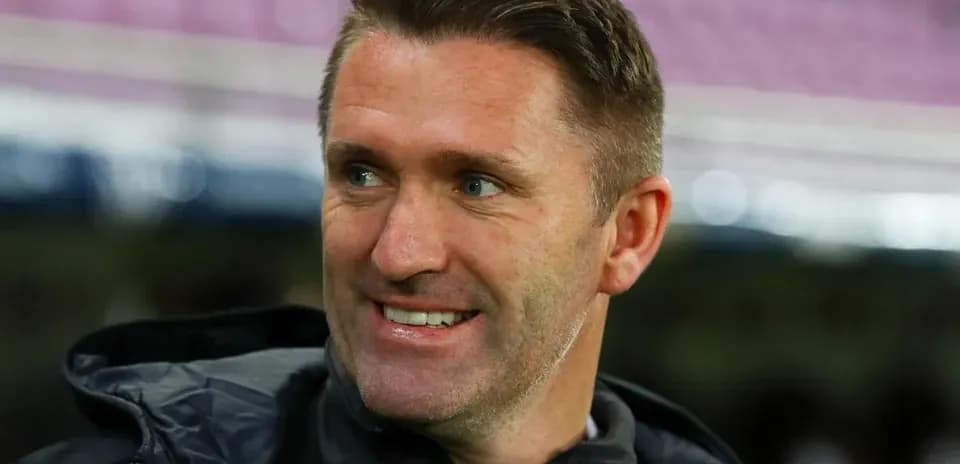 Coach smiling during a match warm-up