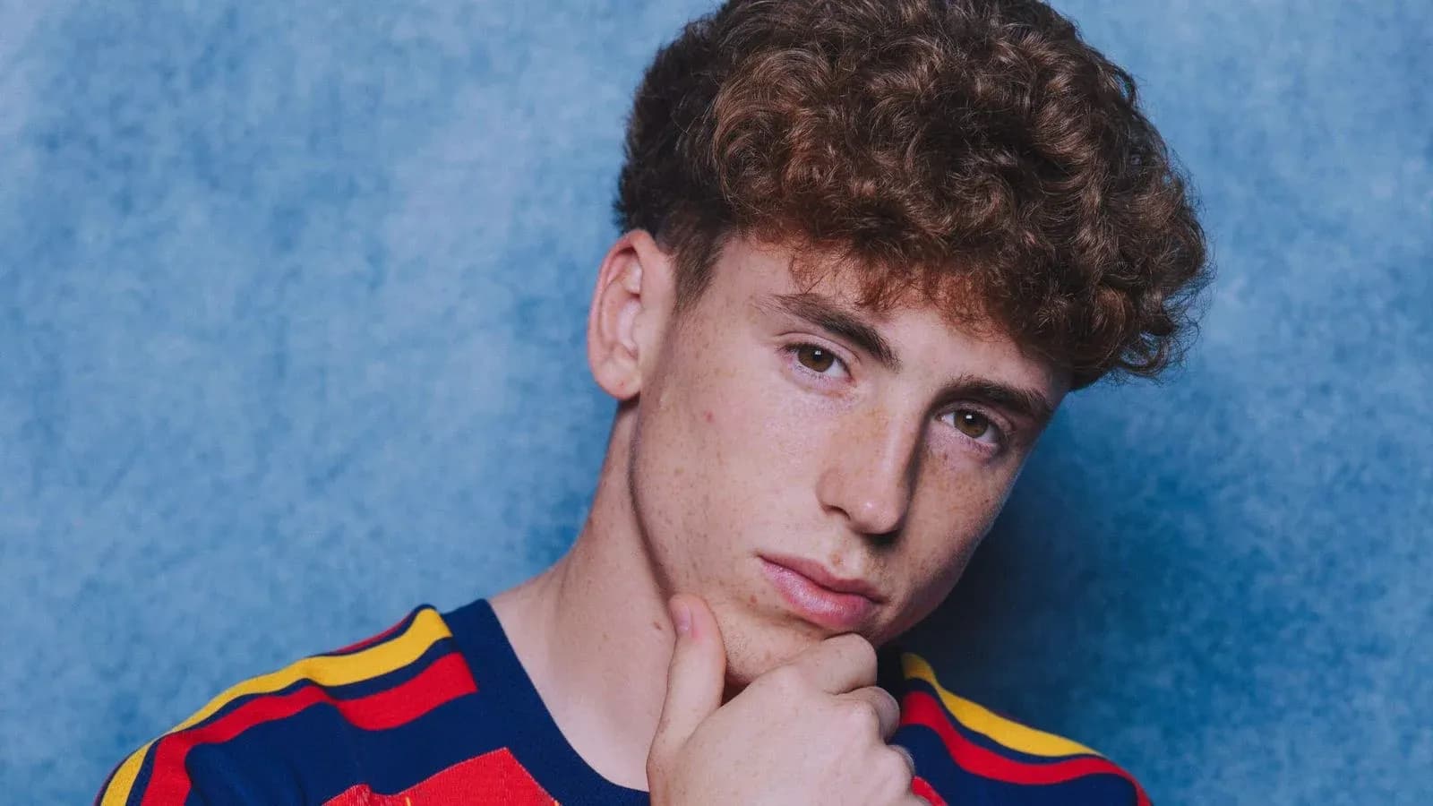 Young person posing with hand on chin