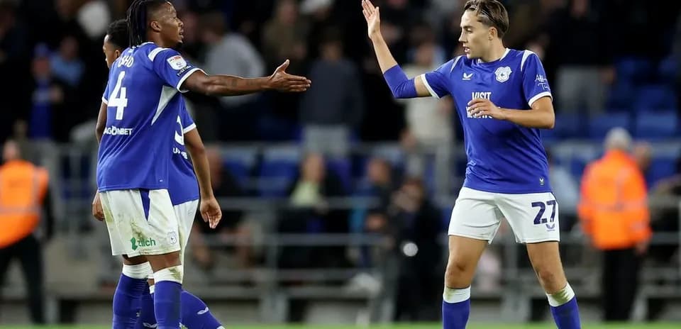 Two Cardiff City players celebrating on the pitch