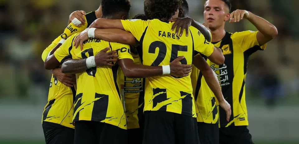 Players celebrating a goal in yellow jerseys