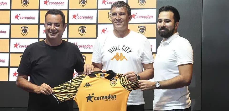New coach holding Hull City jersey at presentation