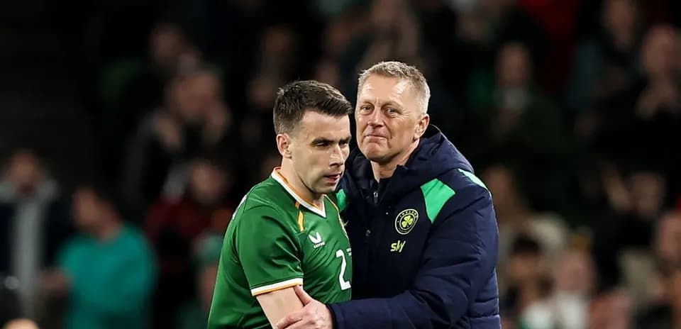Player receiving support from coach after substitution