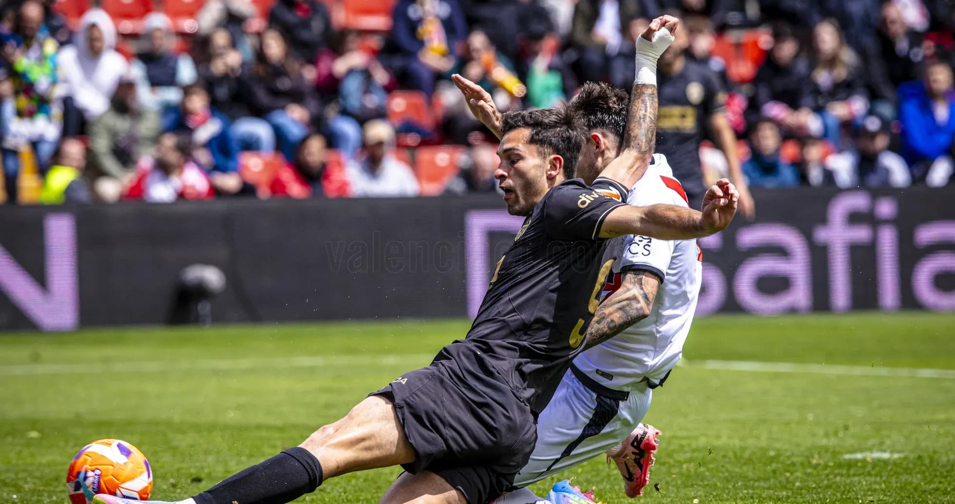 Players clashing during Valencia vs Rayo Vallecano match