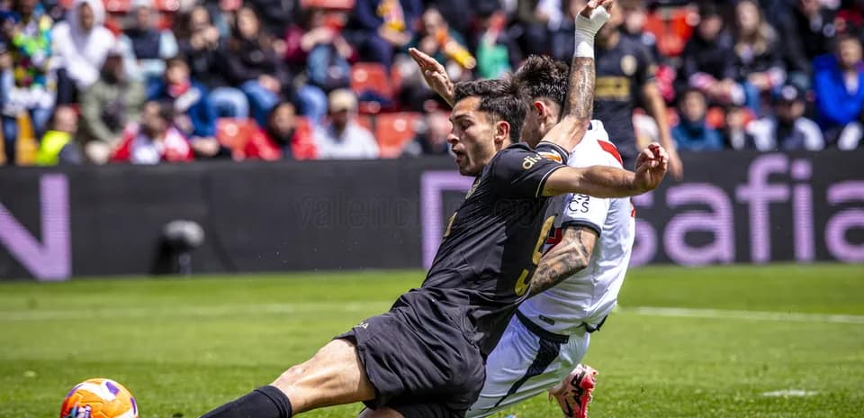 Players clashing during Valencia vs Rayo Vallecano match