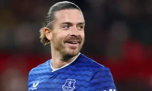 Football player smiling in Everton jersey