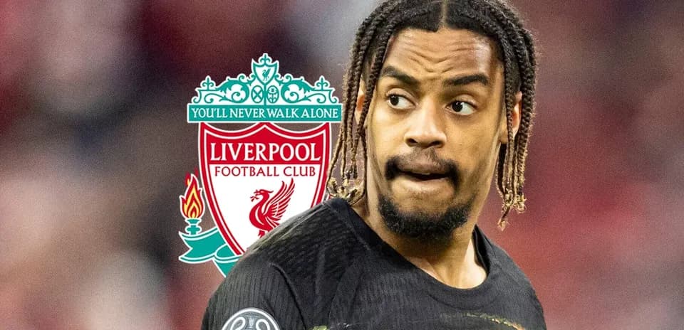 Player in Liverpool jersey with club logo behind