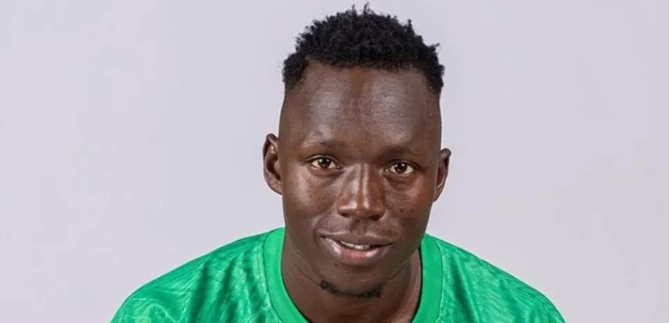 Player posing in green jersey with neutral background