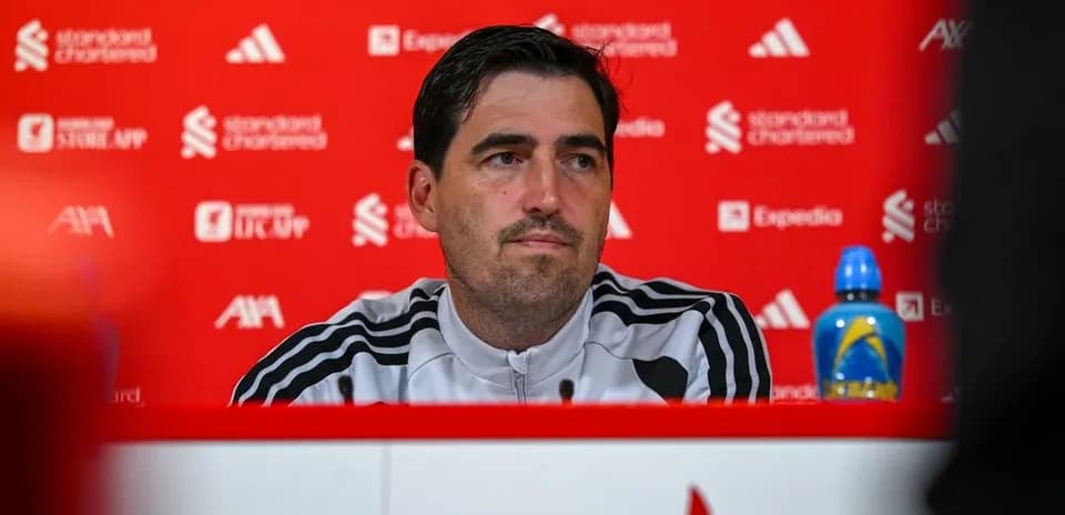 Manager speaking at press conference with backdrop