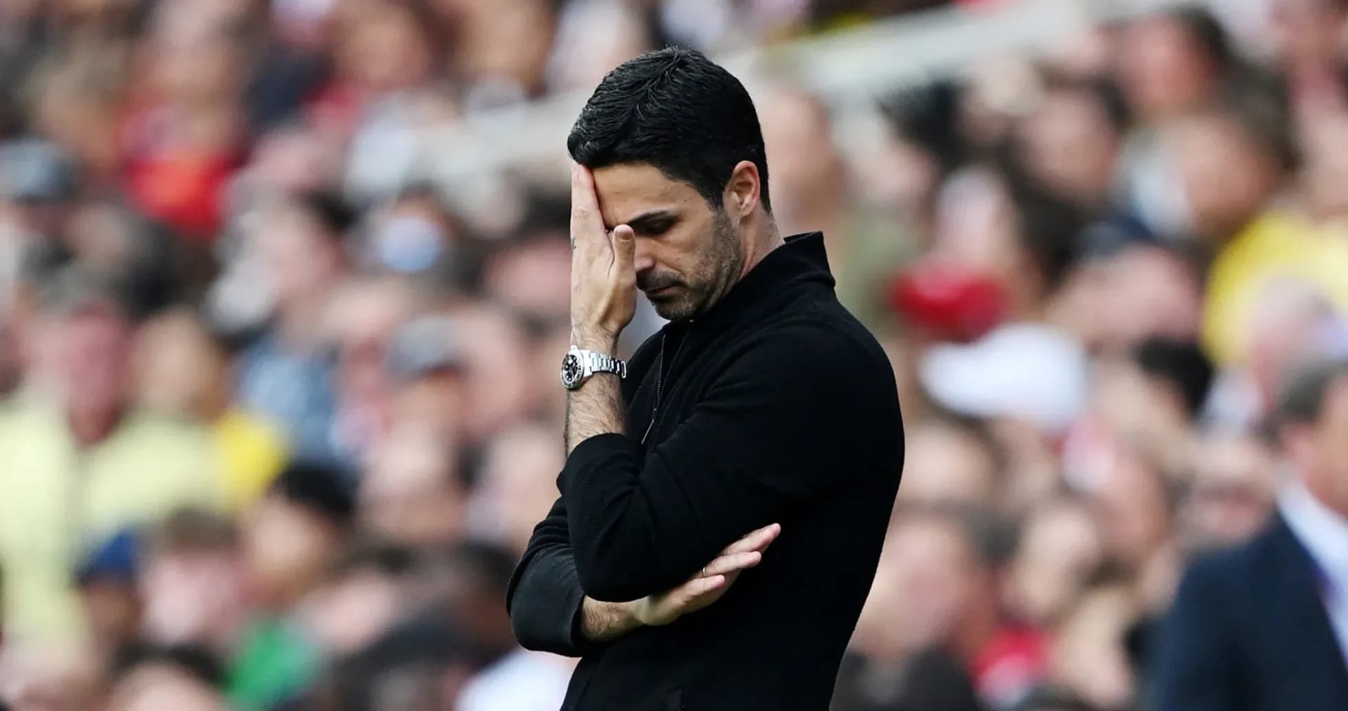 Coach with hand on face during match