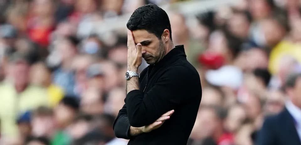 Coach with hand on face during match