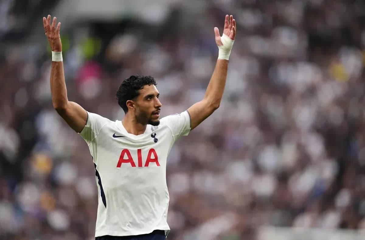 Player gesturing during match wearing Tottenham jersey