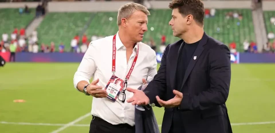 Two coaches discussing on the field post-match
