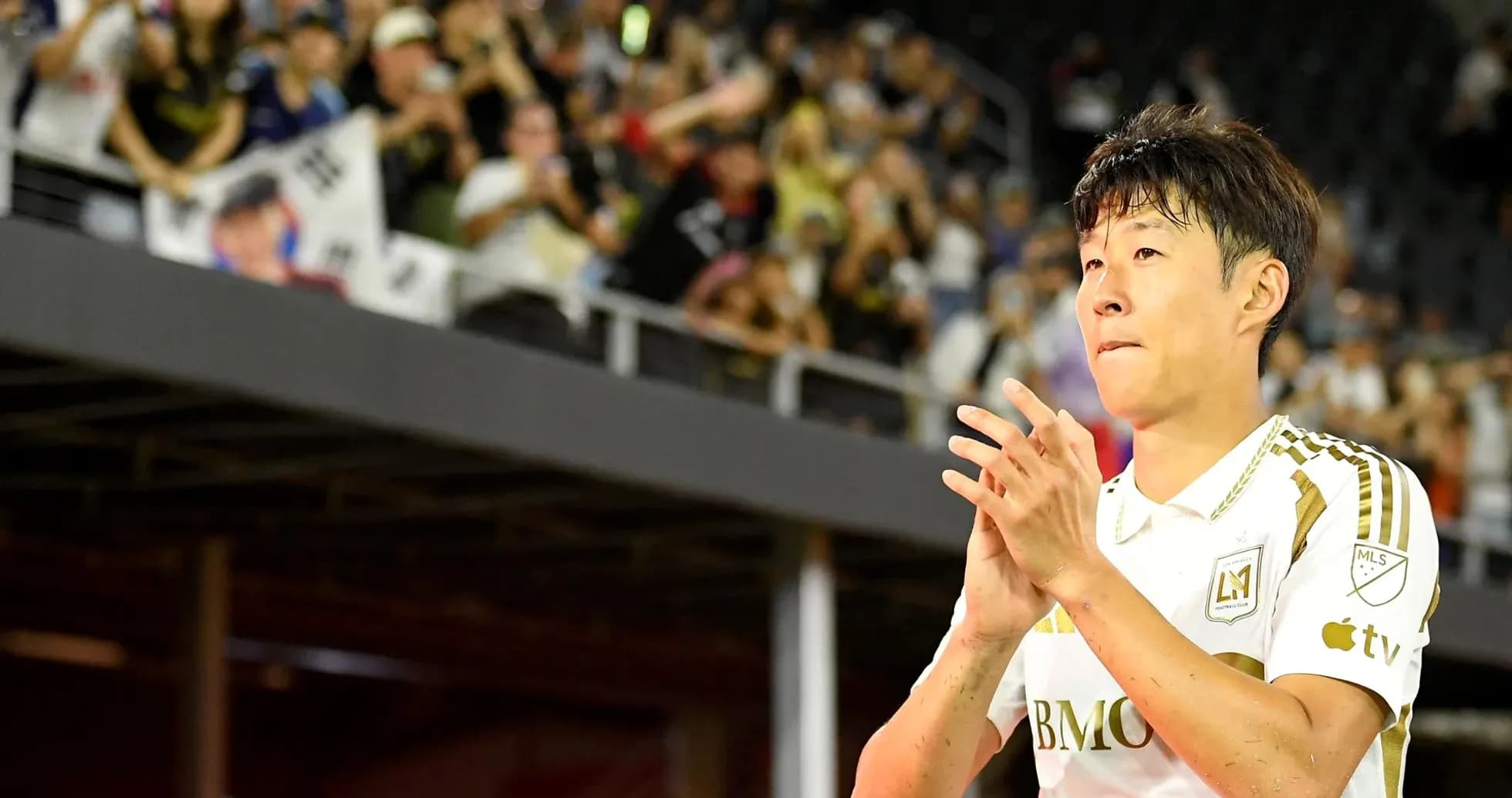 Player clapping to fans in stadium stands