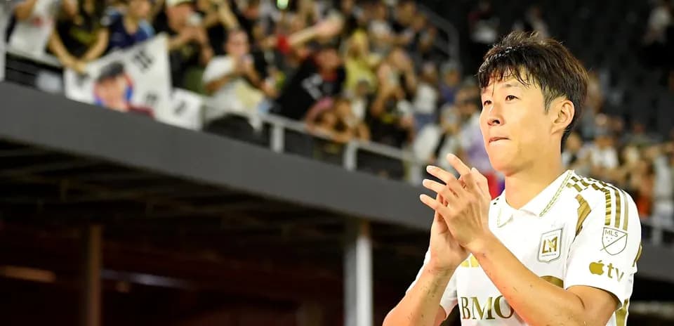 Player clapping to fans in stadium stands