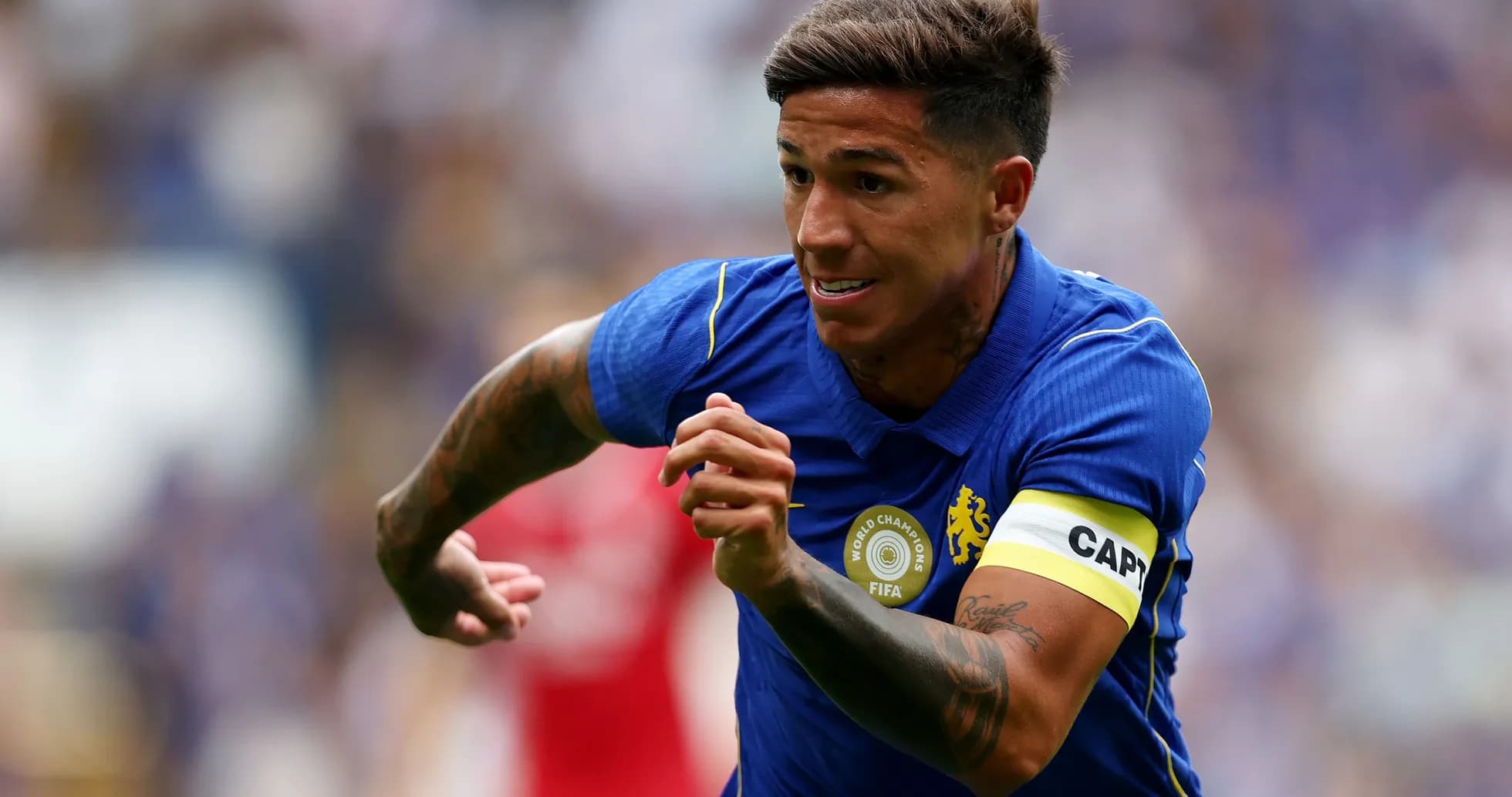 Player in blue jersey sprinting on the field
