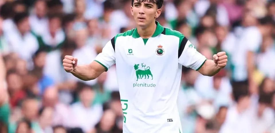 Player celebrating in a white and green jersey