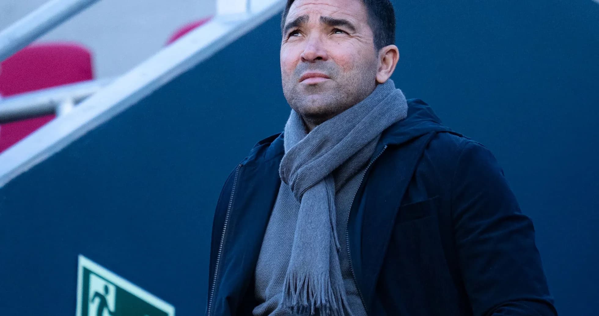 Man in a scarf looking up in stadium