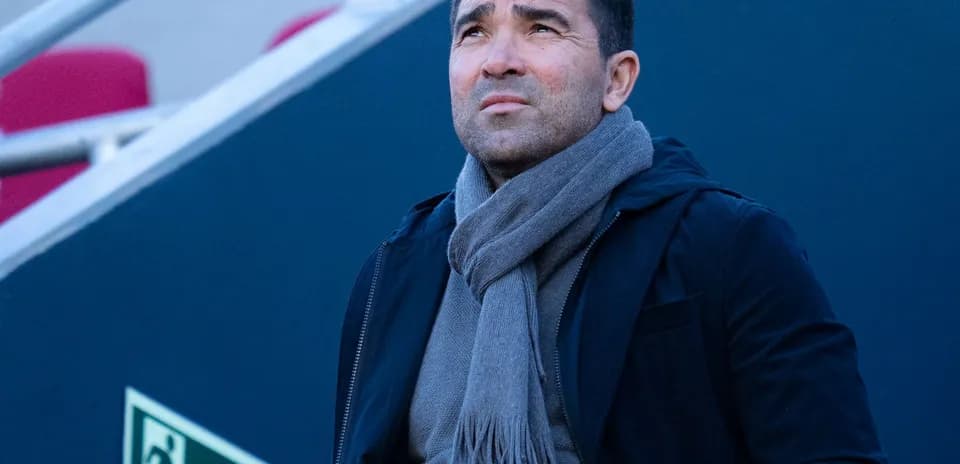 Man in a scarf looking up in stadium