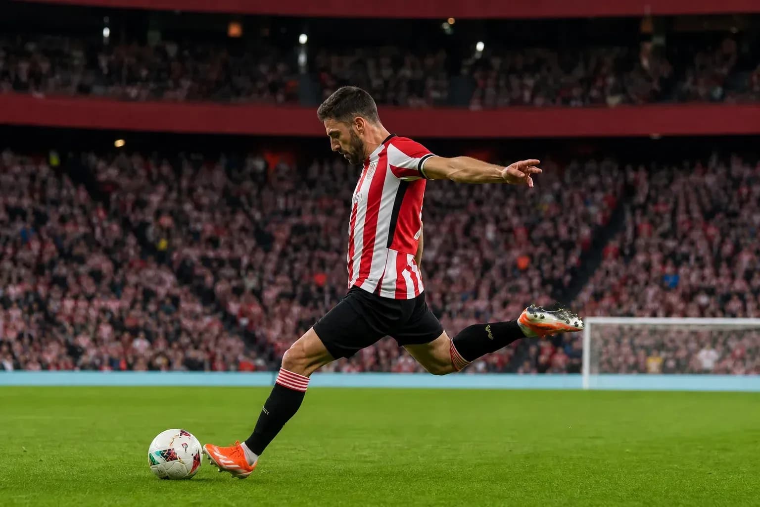 Player kicking the ball during a match