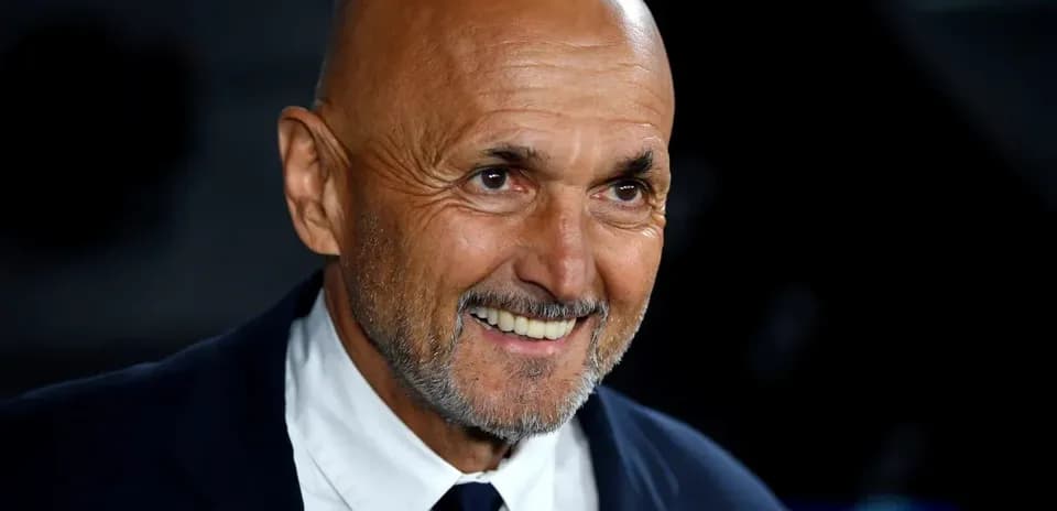Smiling coach wearing a suit during event