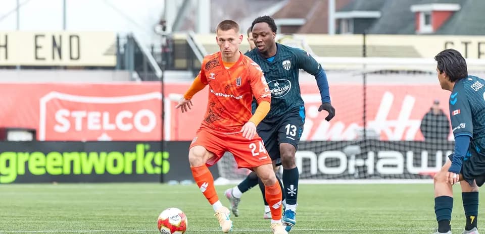 Player dribbling the ball during Forge match