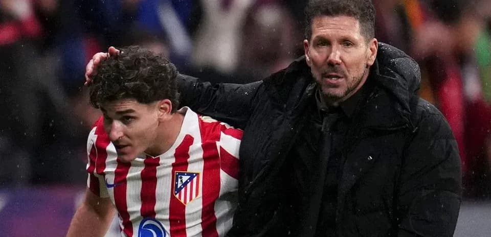 Atletico Madrid player assisted by coach after injury