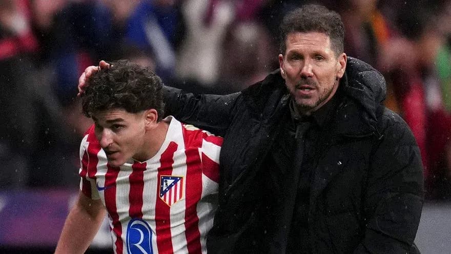 Atletico Madrid player assisted by coach after injury
