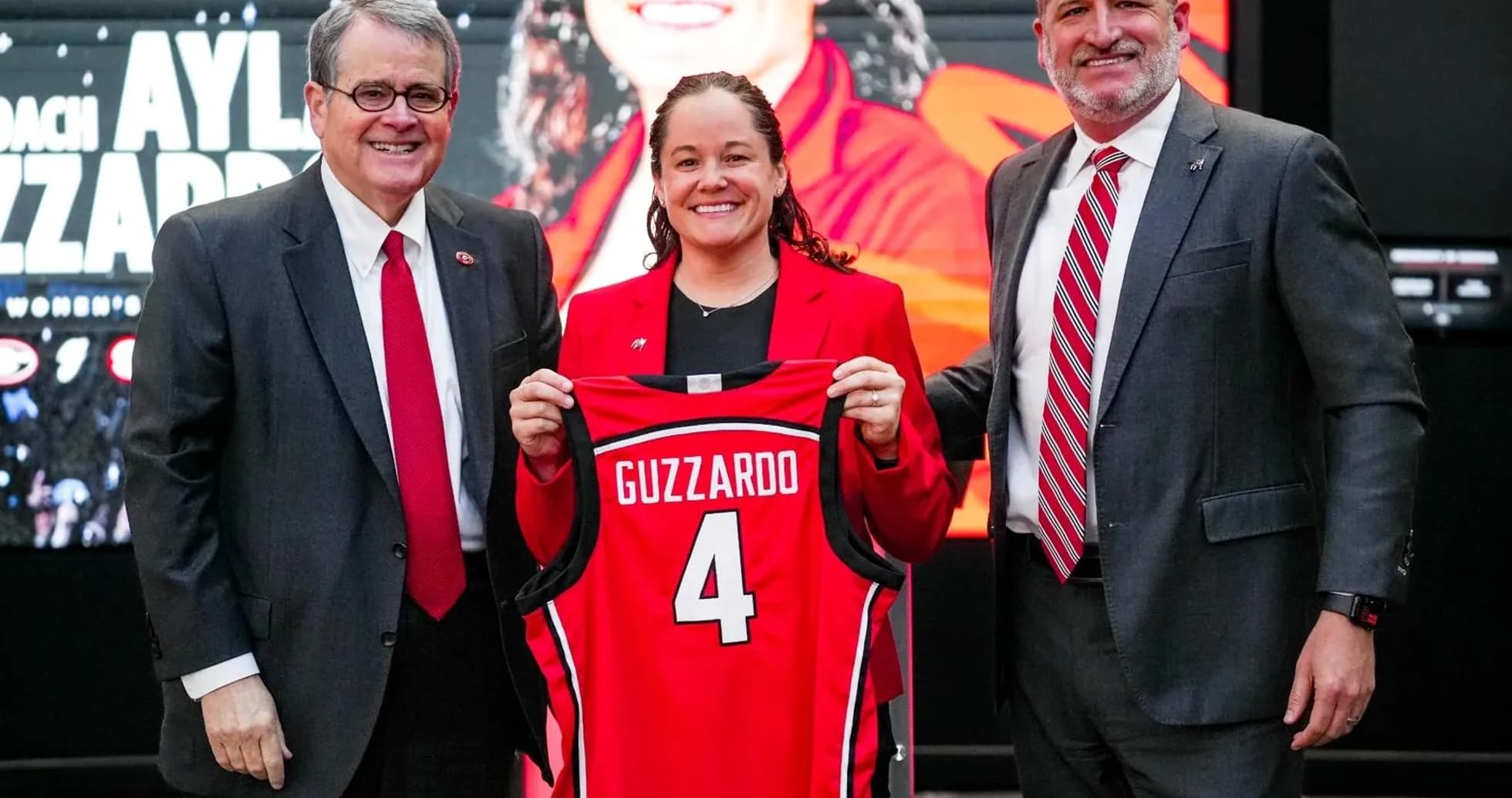 New coach Aylia Guzzardo holding jersey at introduction