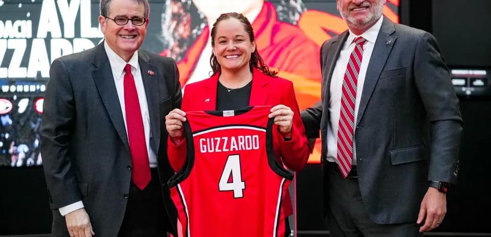 New coach Aylia Guzzardo holding jersey at introduction