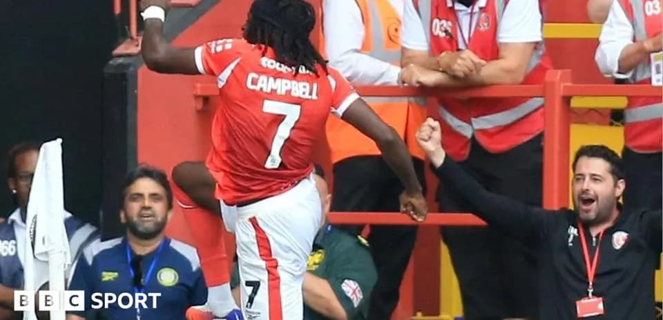 Player celebrating goal with fans in stadium