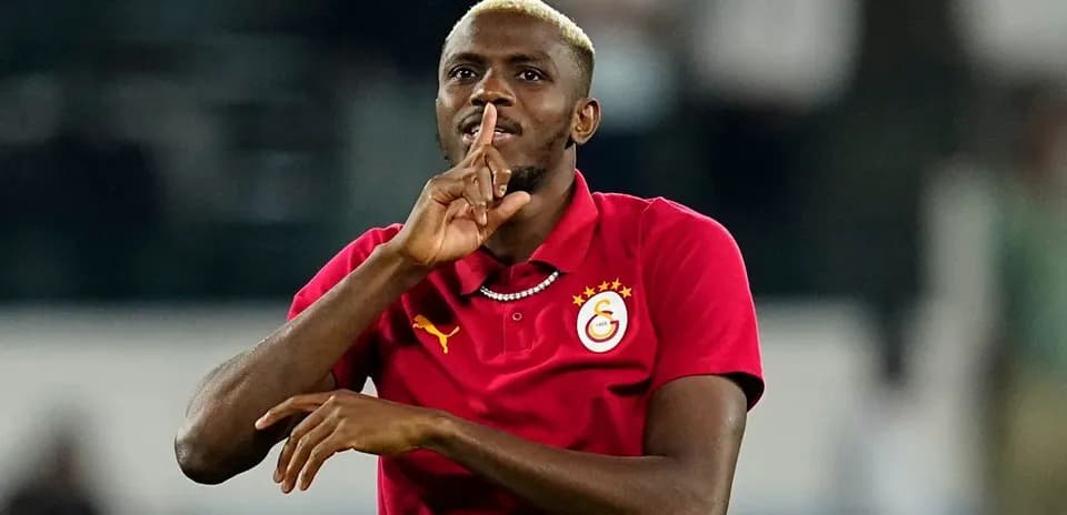 Player making a shushing gesture in red jersey