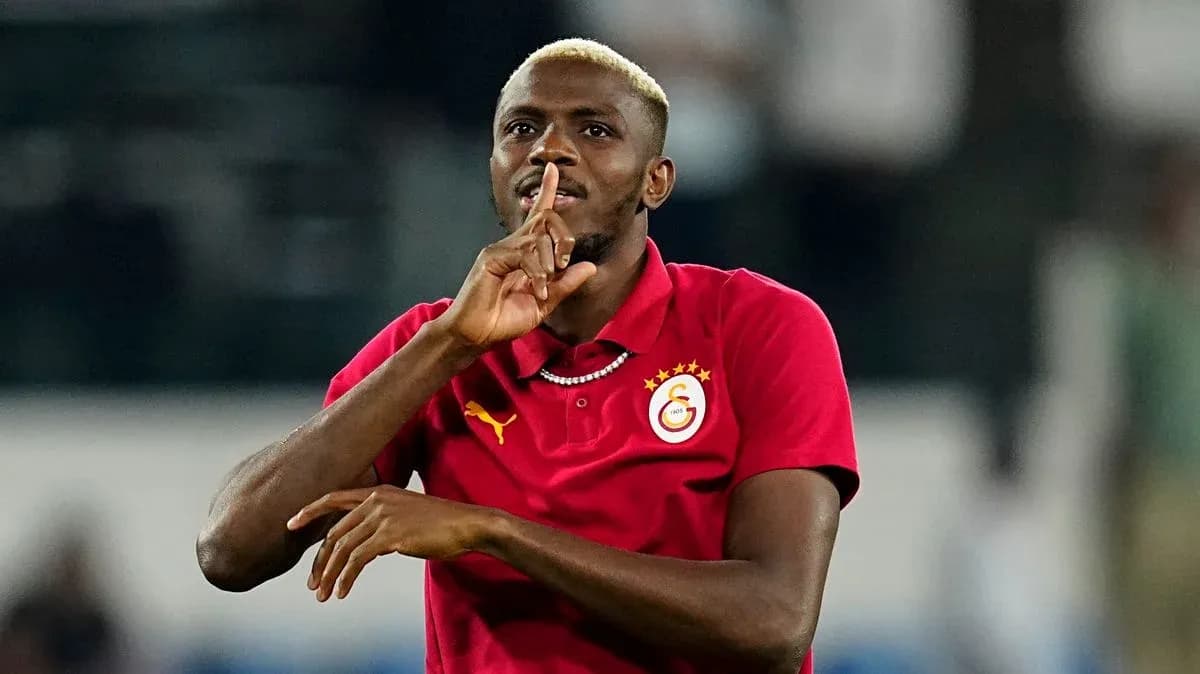 Player making a shushing gesture in red jersey