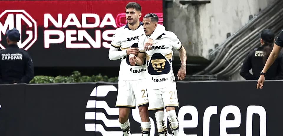 Players celebrating a goal during Liga MX match