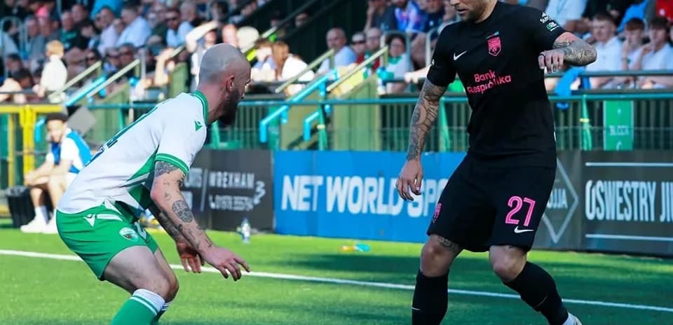 Two players competing for the ball in football match