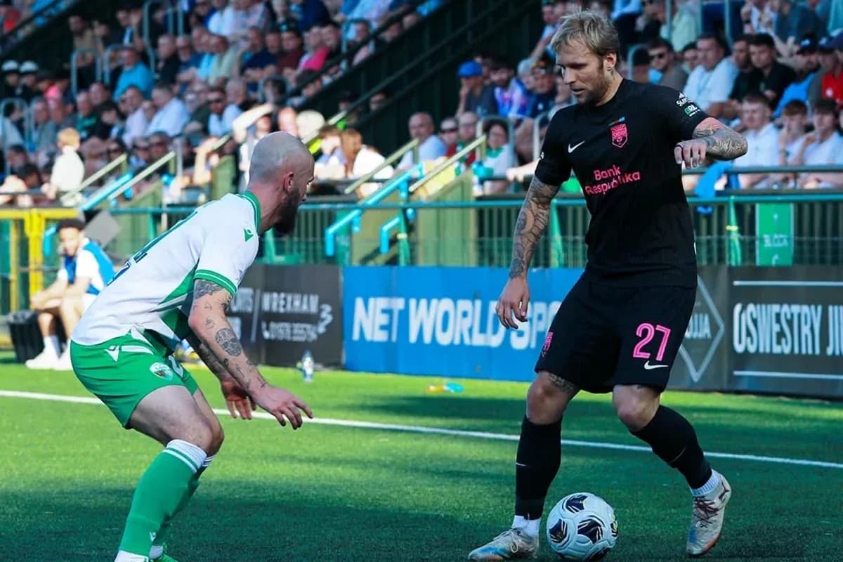 Two players competing for the ball in football match