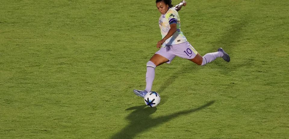 Player kicking soccer ball during match